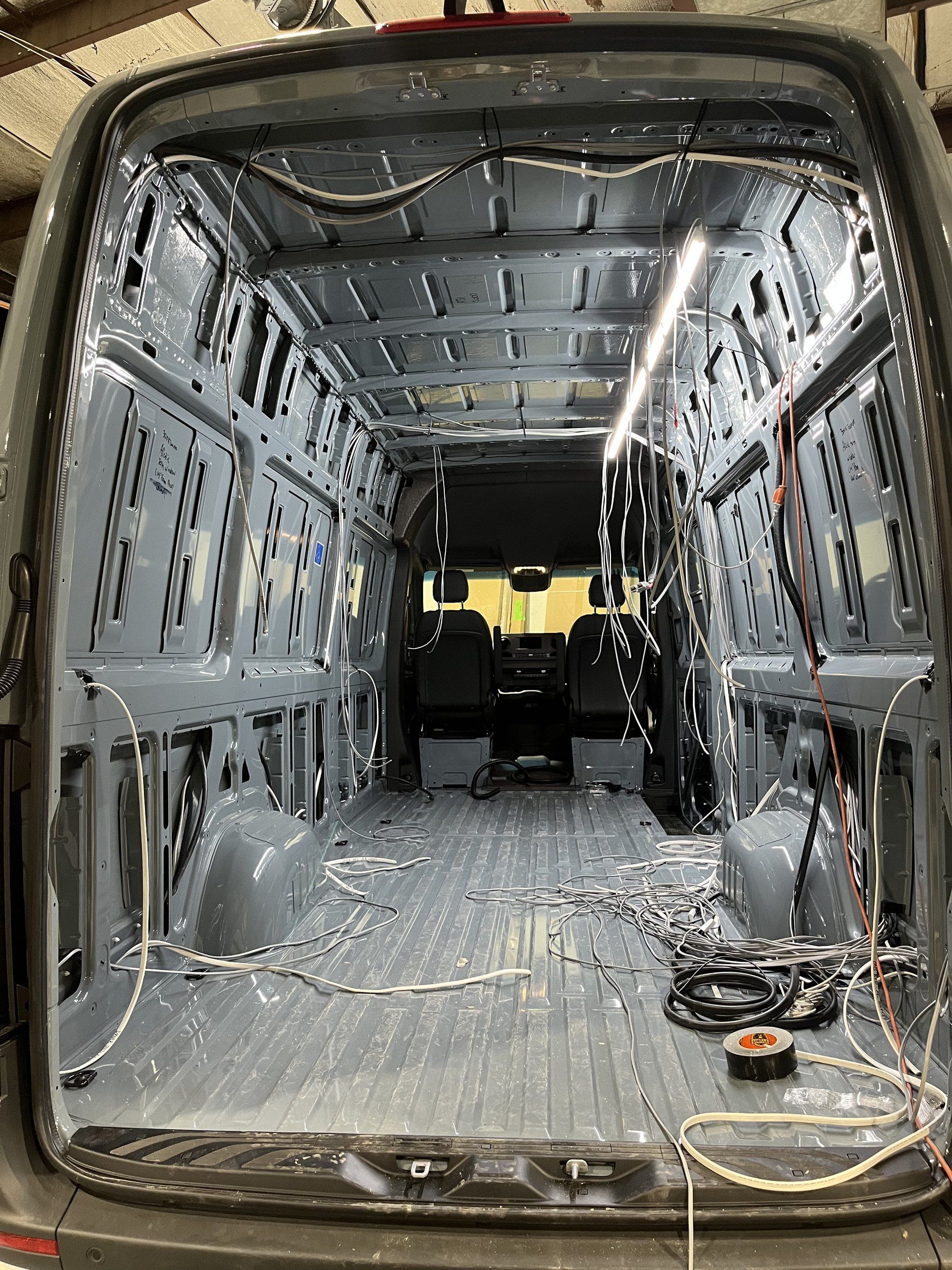 Bare van shell with wiring run before insulation.