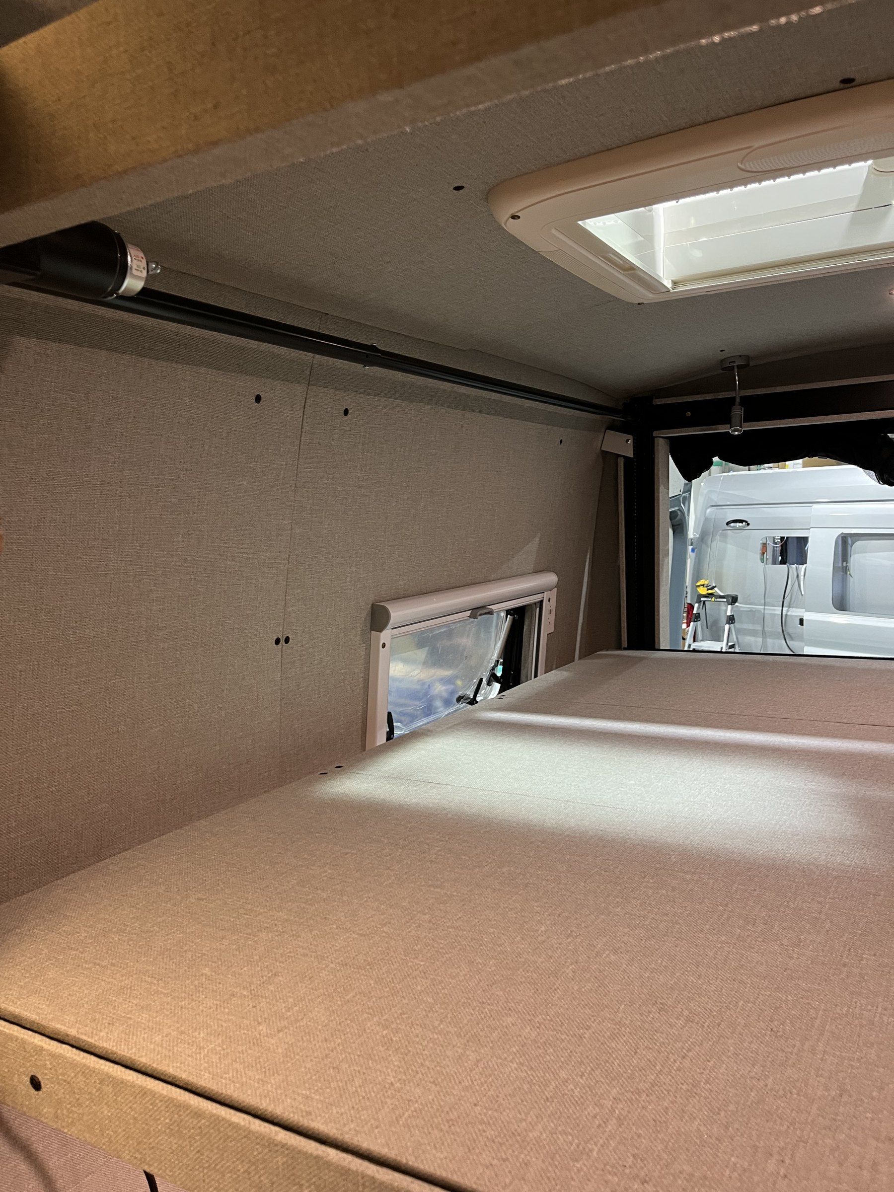 Heki skylight above the bed area with ceiling panels in place.